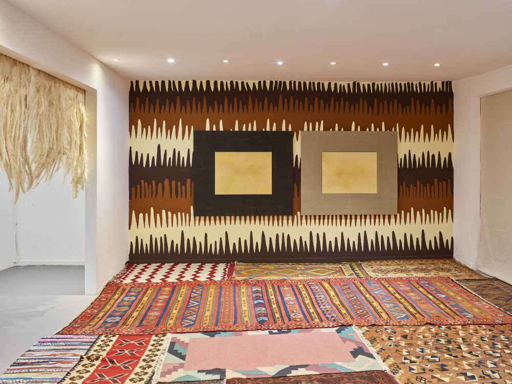 two paintings Mauricio Limon in a wall painting and the space with carpets at wildpalms