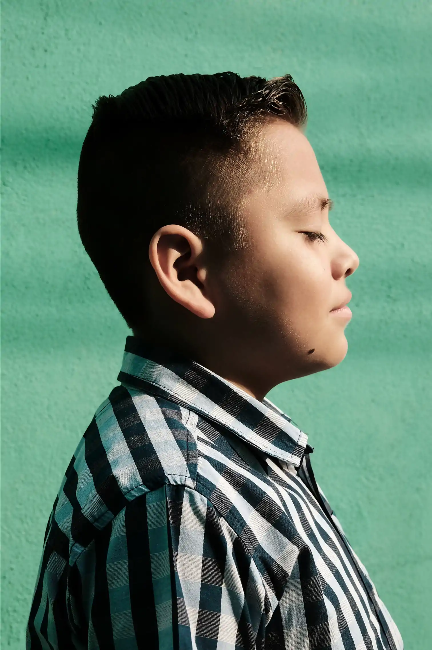 Contemporary social mexican photography. Shuster inhabitant from Iztapalapa in Mexico City. Boy on profil, beautiful light