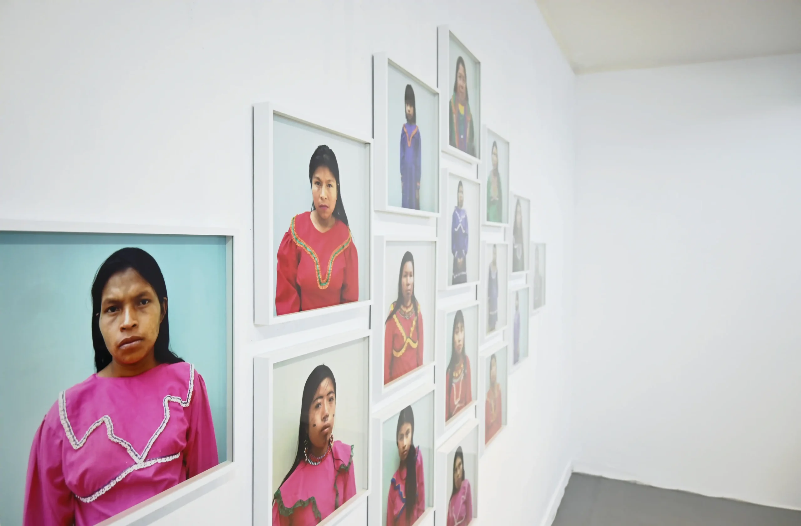 Angled detail of Jepa showing framed portraits of Emberá women in colorful clothing