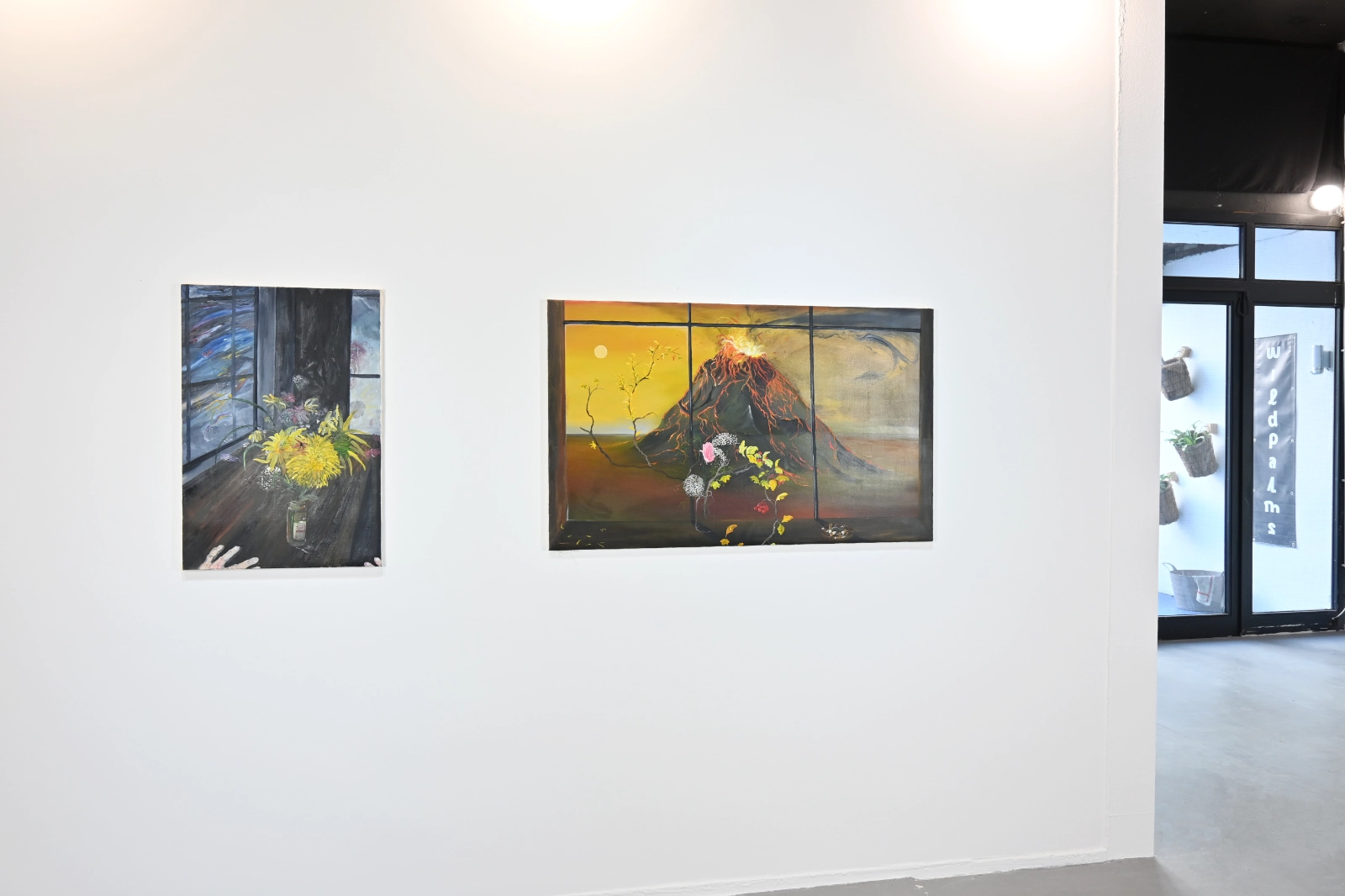 Morgan Mandalay paintings of flowers and a volcano installed near the wildpalms gallery entrance