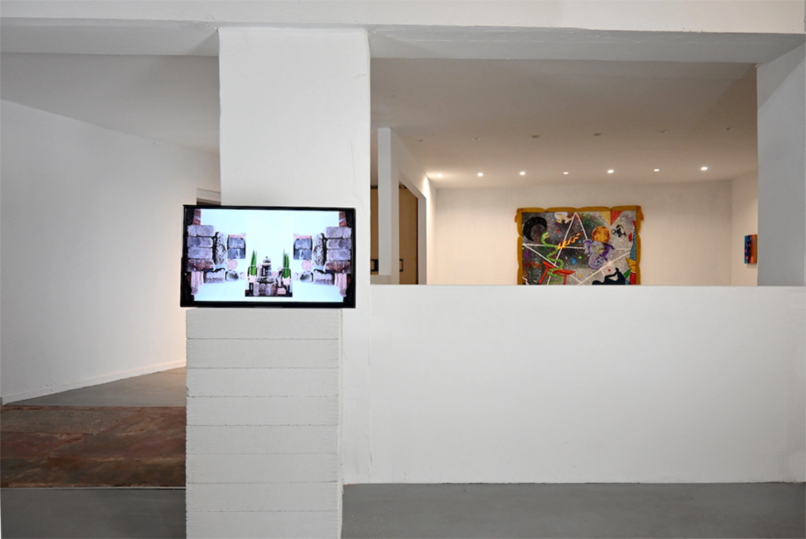 Magical Operations exhibition view with video work and symbolic textile installation
