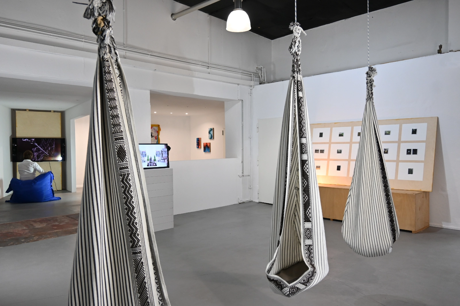 Magical Operations installation view across the wildpalms galleries with woven seats, video works and photographs