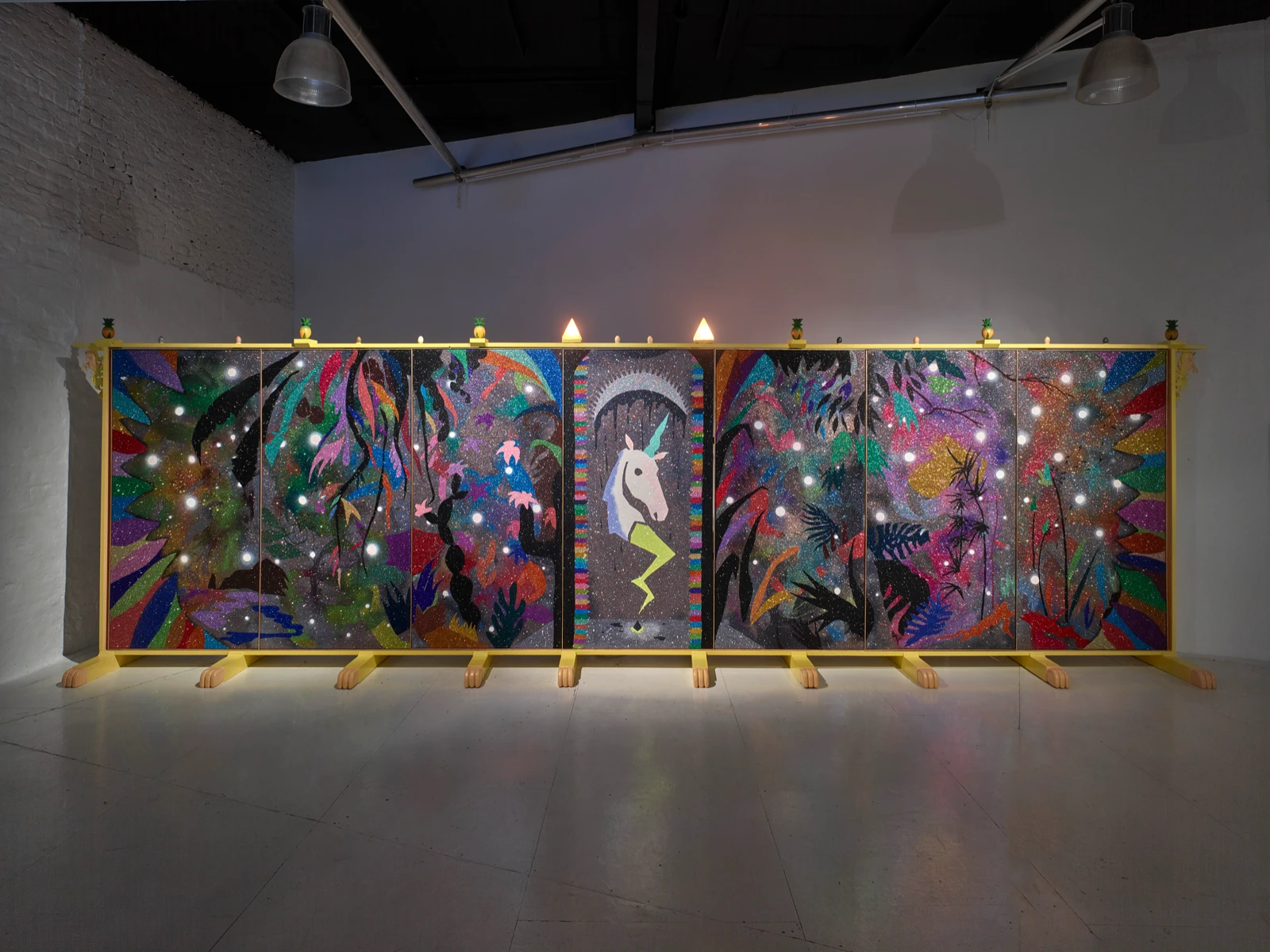 Nika Fontaine's folding-screen painting with a white unicorn at its centre, lit in white gallery light, Quantum Garden of the Supernal Unity at wildpalms